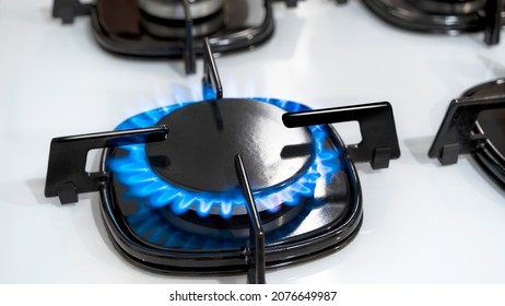 Close up shot of blue fire from domestic kitchen stove top. Gas cooker with burning flames of propane gas. Gas supply chain and news. Global gas crisis and price rise. - Shutterstock ID 2076649987