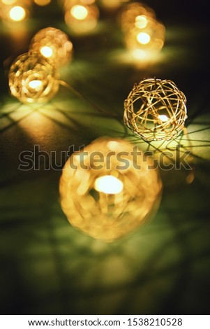 Close up shot of blurred golden Christmas lights making cozy and romantic atmosphere. Festive bukeh background with lights.