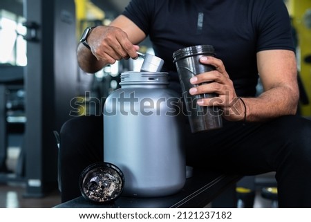 Similar – Image, Stock Photo man taking a weight plate in a gym