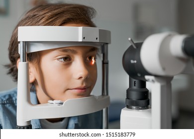 Close up shot of boy checking vision with tonometer at eye clinic - Powered by Shutterstock