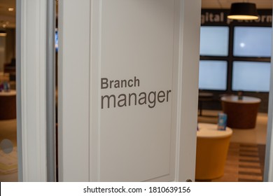 Close Up Shot Of Branch Manager On Partially Open Door