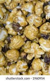 A Close Up Shot Of Carmel Popcorn With Nuts