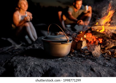 Close up shot of a cauldron. Cooking dinner in field conditions, boiling pot at the campfire. Outdoor adventure, tourism concept. Selective focus