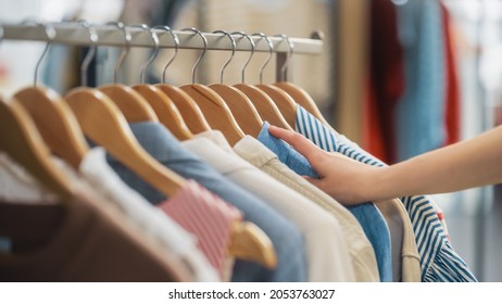 Close Up Shot Of Clothing Rack With Colorful Stylish Items. Shopping Center Interior. Modern Fashionable Shop, Clothes For Every Taste. Fashionable Design, Quality Sustainable Materials. No People.