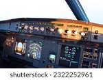 Close up shot, cockpit of a modern commercial airliner. View from pilot seat in landscape mode with focus on auto pilot flight control unit with speed, mach, altitude, primary and navigation display
