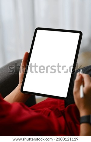 Close up shot creative male freelancer holding stylus pen using digital tablet on sofa Foto stock © 