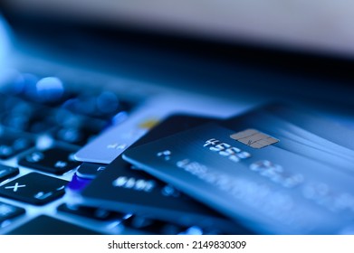 Close up shot of credit card on Laptop computer payment for purchases from online stores and online shopping. Concept of internet purchase. Blue colour tone and selective focus for background - Shutterstock ID 2149830309