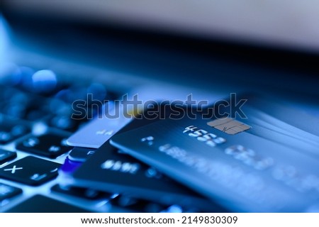 Close up shot of credit card on Laptop computer payment for purchases from online stores and online shopping. Concept of internet purchase. Blue colour tone and selective focus for background