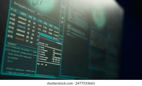 Close up shot of dangerous hacking code running on high tech computer system monitors. Programming scripts shown on PC displays in empty criminal hideout used by hackers to commit illegal activities