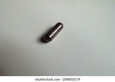 Close Shot Of Dark Purple Capsule Of Bilberry Extract Dietary Supplement