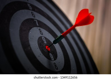Close up shot of the dart arrow hit on bulleyes of dartboard to represent that the business reached the target of company with dark tone picture style. Target and goal as concept.  - Shutterstock ID 1349112656