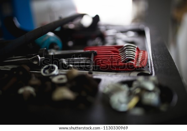 Close up shot of different tools in car repair\
shop or garage