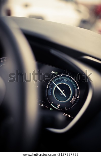 Close up shot of a digital dashboard of a new\
car, showing power and charge.\

