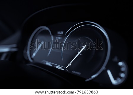 Close up shot with the digital speedometer of a car.