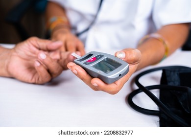 Close up shot of doctor checking sugar level to senior patient women at hospital - concept of healthcare, treatment and - Powered by Shutterstock