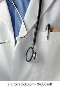 Close Up Shot Of Doctor Wearing Lab Coat, With Stethoscope, Pen Light And Tongue Depressors