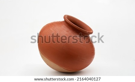 A close up shot of an earthen pot or a clay pot.
