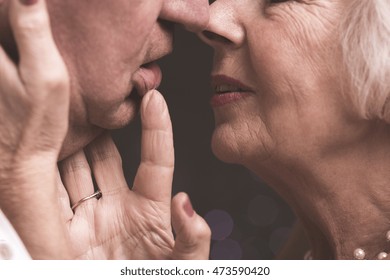 Close Shot Of Elder Couple Close To Kiss, When The Woman Is Touching Man's Face And His Lip