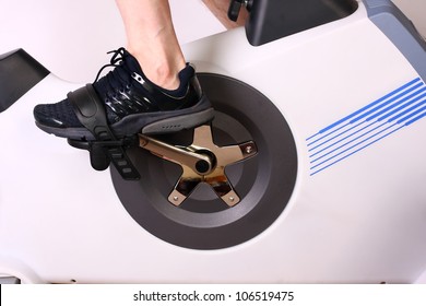 Close Up Shot Of An Exercise Bike With Foot In Pedal