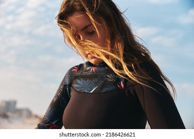 Close In Shot Female Extreme Sports Kite Surfer Prepping Kite On Beach During Sunset