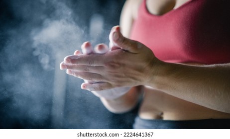 Close Up Shot: Female Weightlifter Dusting Off Chalk From Her Palms. An Athletic Woman Putting Chalk On Her Hands To Start Exercising, Working Out, Training With Weights