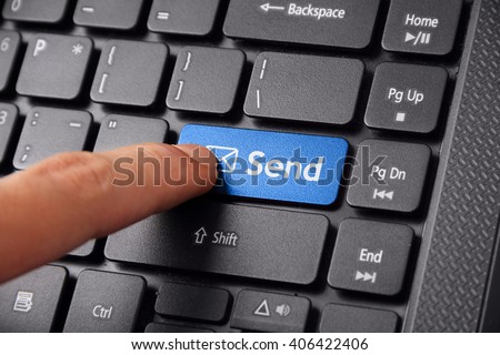 Close up shot of a finger clicking the SEND button on a laptop keyboard