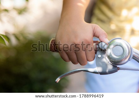 Close up shot finger presses a bicycle bell