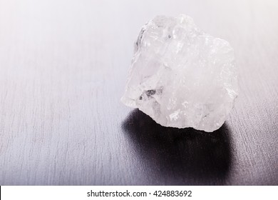 Close Up Shot Of A Fragment Of Rock Crystal Mineral On A Dark Surface