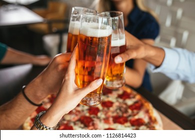 Close Up Shot Of Glasses Of Beer And Pizza