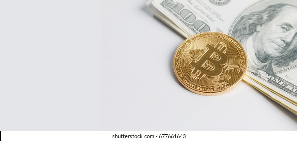 Close up shot gold Bitcoin on dollar banknote over whit background with copy space, ratio for banner design