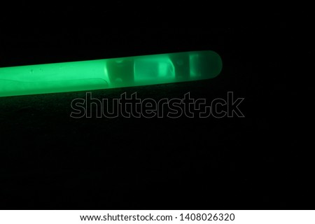 Close up shot of a green glowstick at night