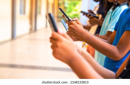 Close Up Shot, Group Of Children Hands Busy Using Smartphone At School Corridor - Concept Of Social Media, Playing Games, Technology And Education