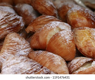 close shot of a group of Neapolitan Sfogliatelle, typical dessert covered with icing sugar - Shutterstock ID 1191476431