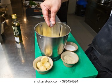 Close Up Shot Of A Hand Dropping Salt Into A Blender.