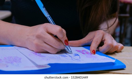 Close up shot - hands of professional tailor, designer drawing fashion sketch at atelier, studio. Dressmaking, creativity and tailoring concept - Shutterstock ID 1528401449