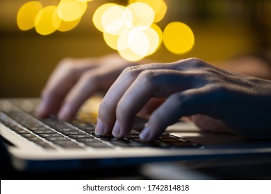 Close Up Shot Of Hands Typing On A Laptop At The Night At Home. WFH. Work From Home For Avoid The Coronavirus COVID 19 Concept.