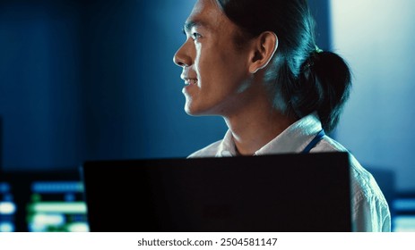 Close up shot of happy employee wandering around data center infrastructure providing processing resources for different workloads. Smiling admin doing analysis on servers - Powered by Shutterstock