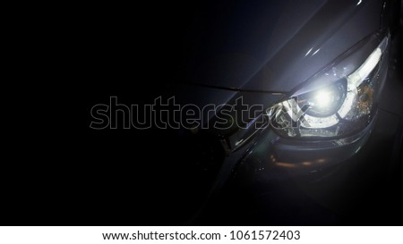 Close up shot of headlight in luxury 
car background with copy space. Modern and expensive sport car concept