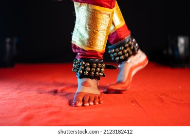 Close up shot of indian bharatanatyam dancer feet with ghungroo kathak or musical anklet dancing on stage - concept of Indian culture, classical dance and traditions