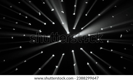 Close up shot of lights setup. Studio with black background, many dots white rays of light shine through the surface, spotlights and searchlights.