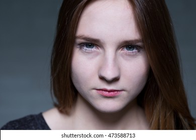 Close shot of long haired and blue-eyed girl's face, who is full of determination - Shutterstock ID 473588713