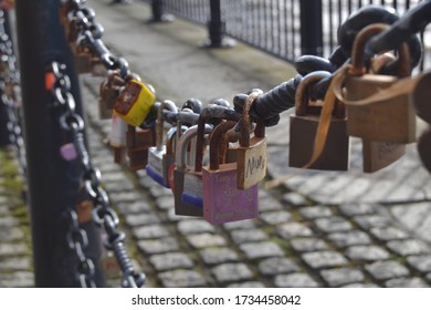 Close up shot of love lock padlocks on chain barriers in Liverpool.
