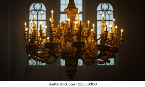 Close Up Shot of a Majestic Golden Chandelier Hanging from the ceiling of a Grand Church. An Antique Piece of Rococo Style Decorates the Cathedral and Lends Light to the Interior of the Building - Shutterstock ID 2253550853
