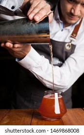 Close Shot Of A Male Bar Tender Making A Delicious Cocktail On A Wooden Bar Counter