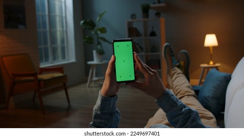 Close up shot of man holding a smartphone with chroma key mock up green screen - technology, connections, communications concept
