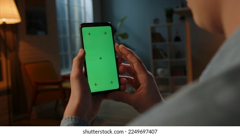 Close up shot of man holding a smartphone with chroma key mock up green screen - technology, connections, communications concept  - Powered by Shutterstock