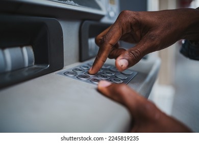 Close up shot of a man typing his PIN code on a keyboard of a ATM to withdrawal money from bank - Shutterstock ID 2245819235