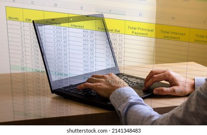 Close up shot of a man working on computer with blended image of a loan amortization table