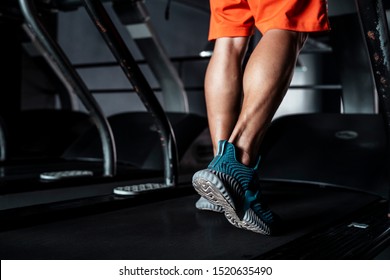 Close up shot of man's legs on a treadmill while he walking slowly. - Powered by Shutterstock