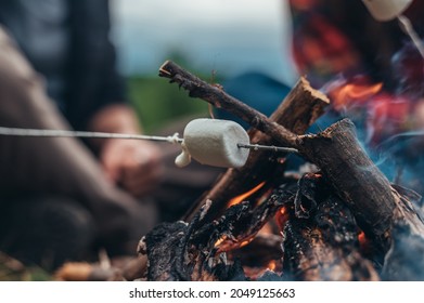 Close Shot Of A Marshmallow On A Stick Above The Camp Fire In The Nature